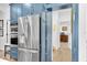 Gourmet kitchen features stainless steel appliances, blue cabinetry, and a door to the pantry at 18714 Chemille Dr, Lutz, FL 33558