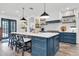 Modern kitchen with a large island, stylish barstools, and a suite of stainless steel appliances at 18714 Chemille Dr, Lutz, FL 33558