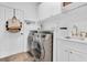 Laundry room with modern washer, dryer, and sink, providing convenience and efficiency at 18714 Chemille Dr, Lutz, FL 33558