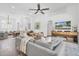 Open concept living area with hardwood floors, an entertainment center, and comfortable seating at 18714 Chemille Dr, Lutz, FL 33558