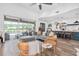Bright, open living room boasts modern furnishings, seamless flow to outdoor pool, and views of the backyard at 18714 Chemille Dr, Lutz, FL 33558