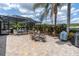 Paver patio with outdoor dining area and enclosed pool, perfect for entertaining at 18714 Chemille Dr, Lutz, FL 33558