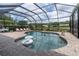 Enclosed pool area with brick pavers, lounge chairs, decorative plants, and a view of the pond and neighborhood at 18714 Chemille Dr, Lutz, FL 33558