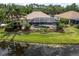 An inviting screened-in pool is surrounded by lush landscaping and overlooks a tranquil pond at 18714 Chemille Dr, Lutz, FL 33558