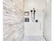 Modern walk-in shower featuring tile walls, a rainfall showerhead, and recessed shelving for added convenience at 18714 Chemille Dr, Lutz, FL 33558
