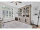 Elegant study featuring wood floors, shuttered windows, and a large built-in bookcase for storage and display at 18714 Chemille Dr, Lutz, FL 33558