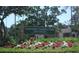 Clearwater Country Club entrance sign with colorful flowers, manicured hedges, and a welcoming atmosphere at 200 N Betty Ln # 5F, Clearwater, FL 33755