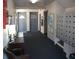 Hallway with mailboxes, unit doors, a table with a lamp, and artwork, creating a welcoming entrance to the building at 200 N Betty Ln # 5F, Clearwater, FL 33755