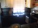 Updated kitchen featuring dark countertops and stainless steel appliances, with a window view at 200 N Betty Ln # 5F, Clearwater, FL 33755