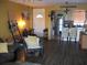 Living room with wood floors leads to an updated kitchen featuring stainless steel appliances at 200 N Betty Ln # 5F, Clearwater, FL 33755