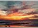 Gorgeous sunset sky with orange and pink clouds reflecting in the ocean water at 200 N Betty Ln # 5F, Clearwater, FL 33755