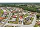 An aerial view highlights the home's location in a quiet residential community with mature landscaping at 2004 Berry Roberts Dr, Sun City Center, FL 33573