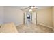Bedroom featuring tile floors, a ceiling fan, and double doors that provide lots of light at 2004 Berry Roberts Dr, Sun City Center, FL 33573