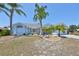 Charming single-story home featuring mature palm trees and a well-manicured lawn at 2004 Berry Roberts Dr, Sun City Center, FL 33573