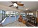 Open living room with sunroom access, featuring multiple ceiling fans and tile flooring at 2004 Berry Roberts Dr, Sun City Center, FL 33573