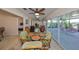 Bright living room connected to outdoor space, featuring ceiling fans and neutral decor at 2004 Berry Roberts Dr, Sun City Center, FL 33573