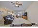 Well-lit living room with comfortable seating, a bay window, and a ceiling fan at 2004 Berry Roberts Dr, Sun City Center, FL 33573