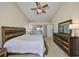 Inviting primary bedroom featuring a wooden bed frame, dresser, and access to the outdoors at 2004 Berry Roberts Dr, Sun City Center, FL 33573