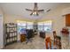 Charming office space filled with natural light, featuring a ceiling fan, desk, and shelving at 2004 Berry Roberts Dr, Sun City Center, FL 33573