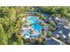 Aerial view of the community pool and recreational area with palm trees, lounge chairs, and various water features at 20203 Merry Oak Ave, Tampa, FL 33647