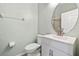 Bright bathroom with a modern vanity, decorative wall texture, and stylish, round mirror at 20203 Merry Oak Ave, Tampa, FL 33647