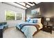 Cozy bedroom featuring a comfortable bed, ceiling fan, wood beams, and a large window for natural light at 20203 Merry Oak Ave, Tampa, FL 33647