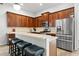 Modern kitchen featuring stainless steel appliances, ample cabinet space, and a breakfast bar with seating at 20203 Merry Oak Ave, Tampa, FL 33647