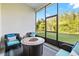 Screened-in patio with fire pit and seating, offering serene views of the landscaped backyard at 20203 Merry Oak Ave, Tampa, FL 33647