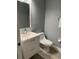 Clean half-bathroom with a modern vanity, toilet, and neutral-toned walls at 2111 Park Crescent Dr, Land O Lakes, FL 34639