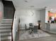 Modern dining room with seating for four, stylish lighting, and adjacent staircase at 2111 Park Crescent Dr, Land O Lakes, FL 34639