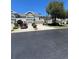Inviting townhome with a well-maintained lawn, driveway, and two car garage under a clear blue sky at 2111 Park Crescent Dr, Land O Lakes, FL 34639
