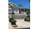 Charming two-story townhome featuring a two-car garage, beautiful landscaping, and a welcoming entrance at 2111 Park Crescent Dr, Land O Lakes, FL 34639