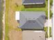 Birds eye view of a home featuring a gray roof and lawn near a water source at 21506 Snowy Orchid Ter, Land O Lakes, FL 34637