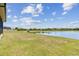 Spacious backyard that leads to a tranquil water view, enhancing the property's appeal at 21506 Snowy Orchid Ter, Land O Lakes, FL 34637