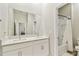 Bathroom featuring double sinks with quartz countertops, white cabinets, and a tiled shower/tub combo at 21506 Snowy Orchid Ter, Land O Lakes, FL 34637
