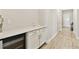 Butler's pantry features white cabinets, a wine fridge, and light countertops at 21506 Snowy Orchid Ter, Land O Lakes, FL 34637