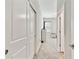 Hallway view leading to a carpeted bedroom with dresser, window and ceiling fan at 21506 Snowy Orchid Ter, Land O Lakes, FL 34637