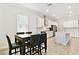 Modern kitchen with island, stainless appliances, tile floors, and open to dining room at 21506 Snowy Orchid Ter, Land O Lakes, FL 34637