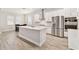 Bright kitchen features an island, stainless appliances, tile floors, white cabinets, and a dining nook at 21506 Snowy Orchid Ter, Land O Lakes, FL 34637