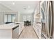 Open kitchen layout with island, stainless appliances, quartz countertops, and dining area at 21506 Snowy Orchid Ter, Land O Lakes, FL 34637