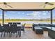 Spacious screened-in patio with ample seating overlooks the water, perfect for outdoor dining and entertaining at 21506 Snowy Orchid Ter, Land O Lakes, FL 34637