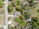 Aerial view showcases a home surrounded by lush foliage, complete with multiple outbuildings and easy road access at 2231 Nichols Rd, Lithia, FL 33547