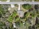 An aerial shot showcases the home's setting within a vast, tree-lined landscape with a lengthy road frontage at 2231 Nichols Rd, Lithia, FL 33547