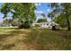 Expansive backyard surrounded by mature trees provides a serene outdoor space for relaxation and recreation at 2231 Nichols Rd, Lithia, FL 33547
