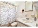 Cozy bathroom with a shower featuring a patterned curtain, vintage vanity, and decor at 2231 Nichols Rd, Lithia, FL 33547