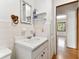Bright bathroom with a vintage vanity, mirror, and tiled walls, providing classic charm at 2231 Nichols Rd, Lithia, FL 33547
