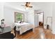 Bright bedroom featuring wood floors, a large window, and a view to another room at 2231 Nichols Rd, Lithia, FL 33547