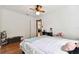 Comfortable bedroom with a ceiling fan, wood floors, and a view into the next room at 2231 Nichols Rd, Lithia, FL 33547