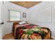 Charming bedroom with a decorative blanket, wood floors, and a bright window at 2231 Nichols Rd, Lithia, FL 33547