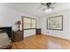 Bright bedroom featuring wood floors, two windows, and a vintage decor at 2231 Nichols Rd, Lithia, FL 33547
